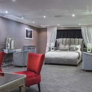image of Goulding suite bedroom in the park liverpool hotel king size bed and desk and large space